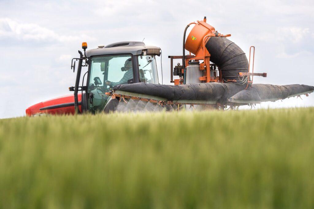 Tractor spreading pesticides